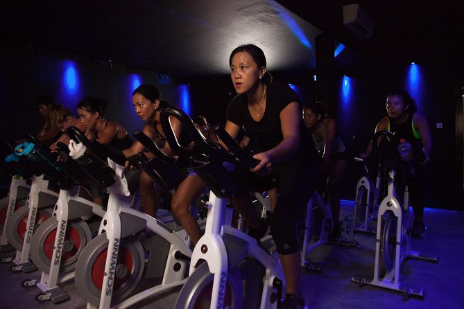 Group Fitness Classes and Open Gym - Rhythmic Cycling Under Special Lighting